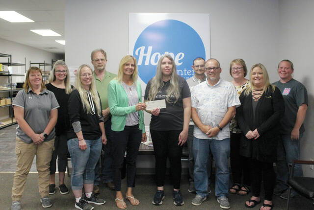 129910728_web1_teams-a-n-b-metroplains-
Two teams of Metroplains employees presented a check to Valvial Vee Jeffrey, manager of the Hope Center, on Thursday, Aug. 17. Both teams regularly volunteer at the center helping to organize the shelves at the food bank. Pictured here are teams #1 and #2: from left, Terri Schuler, Sarah Coenen, Bonnie Rader, Kip Svidal, Joan Tangedal, Vee, Jared Duchscher, Tim Brenno, Devonna Brenno, Sam Dewald and Lisa Westby. In addition to volunteering, they presented a $1,000 check from the Metroplains Management Foundation for the Hope Center.