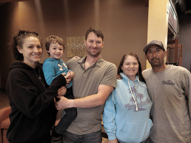 130820845_web1_reuinion_cmyk
From L to R: Charlotte and David Hooge with their son Jacob. Nicole Eagle and her fiance Domingo. Photo courtesy of Charlotte Hooge.