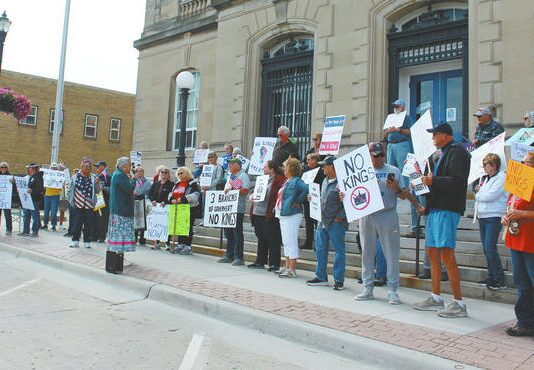 
			
				                                They started gathering at 10 a.m. and by 11:30 a.m. over 80 people had exercised their right to free speach and peaceful assembly guaranteed in the First Amendment of the Constitution of the USA at Devils Lake’s “No Kings” rally on the steps of the Lake Region Heritage Center, main street. Using a microphone and small speaker participants were invited to come forward and tell the crowd why they had come to this event. Although a few passersby expressed their opinions in opposition to the rally, many attending the rally did step up and express their concerns. Across the U.S. over 5 million people participated in the “No Kings” rally, estimated to be the largest demonstration in US history.
 
			
		