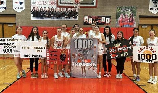 
			
				                                Devils Lake junior guard Tylie Brodina surpassed 1,000 career points in the Firebirds win over Grand Forks Red River. Shes pictured with family and teammates after the game. (Photos courtesy of Christa Brodina)
 
			
		