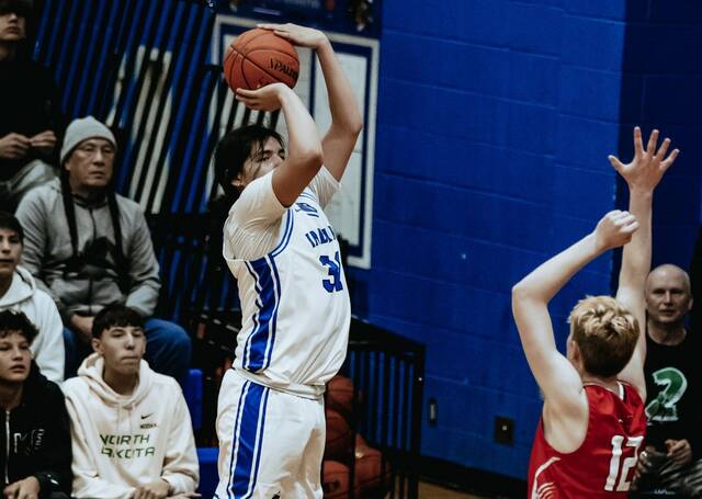 132045664_web1_sonny-alberts-1-5-26-cam
Four Winds/Minnewaukans Sonny Alberts lines up a three-point attempt with Devils Lakes Egan Laite guarding him. (Photo by Cameron Carlson)