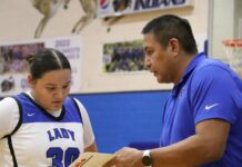 
			
				                                Four Winds/Minnewaukan head coach Sean Gourd Sr. gives instruction to Mercie Morgan during a game. (Photo by Mojo Hill)
 
			
		