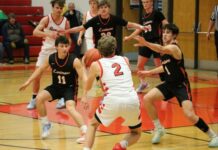
			
				                                Ian Westlind navigates multiple Larimore guards. (Photo by Mojo Hill)
 
			
		