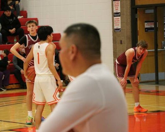 
			
				                                Warwicks Anthony Touche Jr. shoots free throws as head coach Robert Lawrence looks on.
 
			
		
