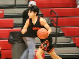
			
				                                Anthony Touche Jr. dribbles past midcourt as he initiates the offense during a game in the 2026 Ramsey County tournament. (Photo by Mojo Hill)
 
			
		