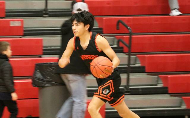Anthony Touche Jr. dribbles past midcourt as he initiates the offense during a game in the 2026 Ramsey County tournament. (Photo by Mojo Hill)
