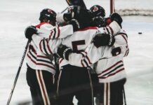 
			
				                                The Devils Lake boys hockey team comes together to support each other. (Photo by Cameron Carlson)
 
			
		