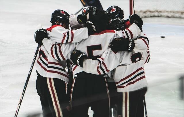 The Devils Lake boys hockey team comes together to support each other. (Photo by Cameron Carlson)