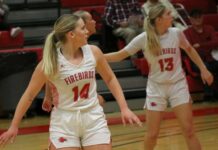 
			
				                                Jenae Martinson (14) and Tylie Brodina (13) turn their heads while watching a play commence farther down the court. (Photo by Mojo Hill)
 
			
		