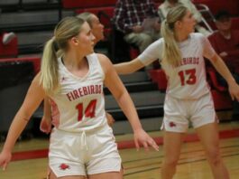 
			
				                                Jenae Martinson (14) and Tylie Brodina (13) turn their heads while watching a play commence farther down the court. (Photo by Mojo Hill)
 
			
		