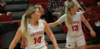 
			
				                                Jenae Martinson (14) and Tylie Brodina (13) turn their heads while watching a play commence farther down the court. (Photo by Mojo Hill)
 
			
		