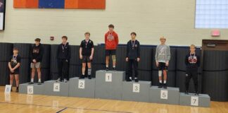 
			
				                                Rylan Samuelson stands atop the podium of the 121 weight class. (Photo via Devils Lake High School Wrestling on Facebook)
 
			
		