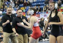 Six Devils Lake girls advance to second day of state wrestling tournament
Jossalin Carpenter and her coaches celebrate moments after coming away with an 8-4 win by decision in the 2026 state wrestling tournament. (Photo by Mojo Hill)