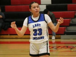 
			
				                                Suri Gourd communicates with her teams bench during Four Winds/Minnewaukans quarterfinal win over Hillsboro/Central Valley at the Devils Lake Sports Center. (Photo by Mojo Hill)
 
			
		