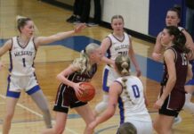 
			
				                                Langdon Area/Munichs Mya Swanson drives into the lane, past the outstretched hand of Benson Countys Addisyn Faul, in the 2025-26 District 4 championship. (Photo by Mojo Hill)
 
			
		