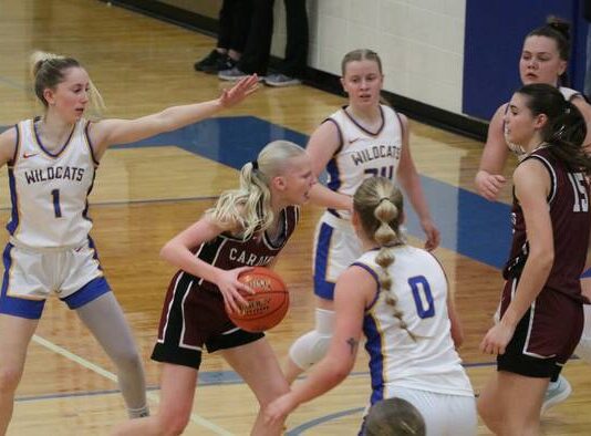 
			
				                                Langdon Area/Munichs Mya Swanson drives into the lane, past the outstretched hand of Benson Countys Addisyn Faul, in the 2025-26 District 4 championship. (Photo by Mojo Hill)
 
			
		