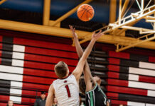 
			
				                                Ben Brodina leaps for the opening tip-off against Thompsons Noah Hippen. (Photo by Cameron Carlson)
 
			
		
