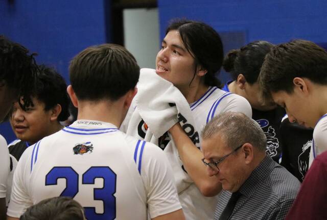 Sonny Alberts wipes off sweat during a timeout for Four Winds/Minnewaukan. (Photo by Mojo Hill)
