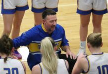 
			
				                                Benson County head coach Bryan Kenner talks to his team during a timeout. (Photo by Mojo Hill)
 
			
		