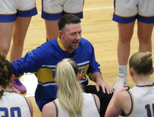 
			
				                                Benson County head coach Bryan Kenner talks to his team during a timeout. (Photo by Mojo Hill)
 
			
		
