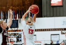 
			
				                                Tylie Brodina extends her arms for a pass in Devils Lakes seventh-place game against Watford City. (Photo by Cameron Carlson)
 
			
		