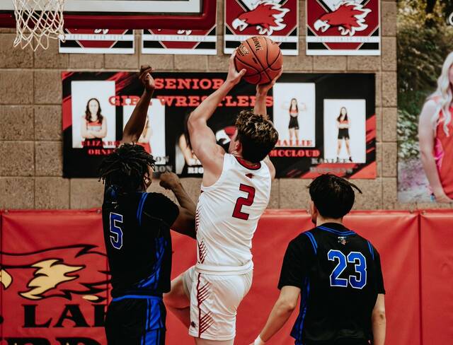 Devils Lakes Mason Palmer leaps past Four Winds/Minnewaukans Marial Deng during a regular-season matchup between the Firebirds and Indians. (Photo by Cameron Carlson)