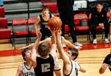 
			
				                                Nelson Countys Zane Anderson reaches up for a ball with Brody Rainsberry watching intently. (Photo by Cameron Carlson)
 
			
		