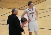 
			
				                                Ben Brodina and Mason Palmer chat with Devils Lake coach Dustin Brodina between plays during the Region 2 championship at Mayville State University. (Photo by Mojo Hill)
 
			
		