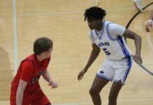 Indians climb out of first-quarter hole to keep season alive against May-Port-C-G
Four Winds/Minnewaukans Marial Deng guards May-Port-C-Gs Bricker Johnson during the Region 2 third-place game at Mayville State University. (Photo by Mojo Hill)