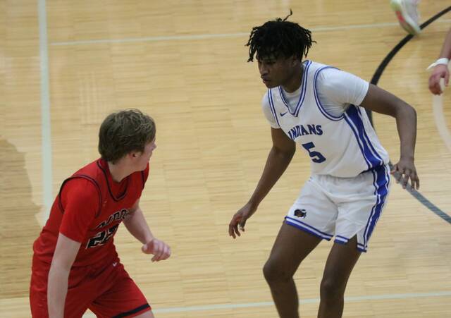 Four Winds/Minnewaukans Marial Deng guards May-Port-C-Gs Bricker Johnson during the Region 2 third-place game at Mayville State University.
PHOTO BY MOJO HILL