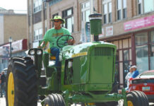 
			
				                                This vintage tractor, shown here in a 4th of July Parade down Main Street of Devils Lake in recent years, demonstrates the wide front tire placement in some John Deere Tractors. (Photo Louise Oleson, DLJ)
 
			
		