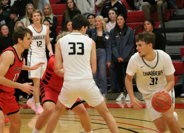 Nelson Countys Rider Schmidt dribbles with North Stars Hunter Hagler guarding him during the 2026 Ramsey County boys basketball tournament at the Devils Lake Sports Center. (Photo by Mojo Hill)