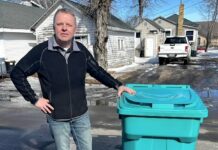 
			
				                                Devils Lake Public Works Director and City Engineer Mike Grafsgaard displays a 95-gallon trash container under consideration for use in conjunction with the new automated sanitation truck expected to arrive in the fall.
                                 Photo by Mark C. Robinson

			
		