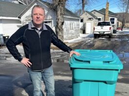 
			
				                                Devils Lake Public Works Director and City Engineer Mike Grafsgaard displays a 95-gallon trash container under consideration for use in conjunction with the new automated sanitation truck expected to arrive in the fall.
                                 Photo by Mark C. Robinson

			
		