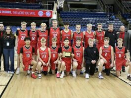 
			
				                                The Devils Lake boys basketball team poses for one last team photo after winning the state third-place game at the Fargodome. (Photo by Mojo Hill)
 
			
		