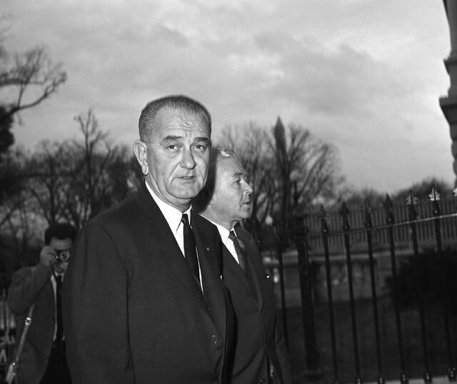 President Lyndon B. Johnson leaves the White House on the way to his old vice-presidential offices in the nearby Executive Office building, Nov. 23, 1963, as he starts a first full day as Chief Executive. With the new president is Rep. Homer Thornberry (D-Tex.).
AP Photo