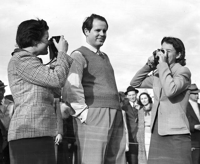 Ralph Guldahl of Madison, N.J., center, who broke the tournament record to win the sixth annual Masters Tournament on April 2, 1939 at Augusta National Golf Club in Augusta, Ga. Guldahl is shown posing for a couple of pro golf players, Katherine Hemphill, left, of Columbia, S.C. and Dorothy Kirby of Atlanta, Ga, who became candid camera fans after completing the final round.
                                 AP Photo