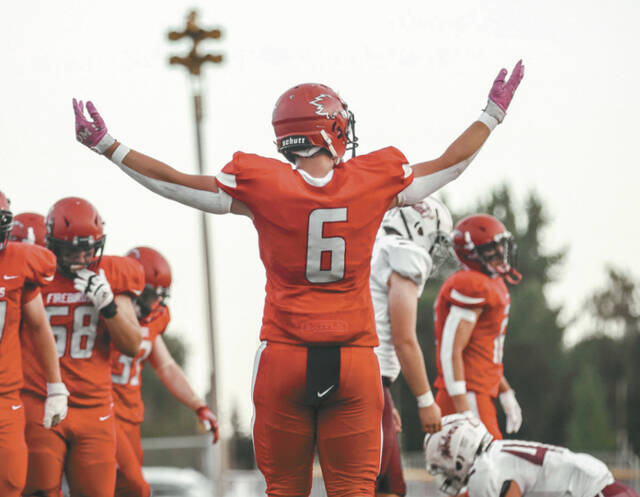 Kade Fee raises his arms during a Devils Lake football game.
                                 Photo by Cameron Carlson