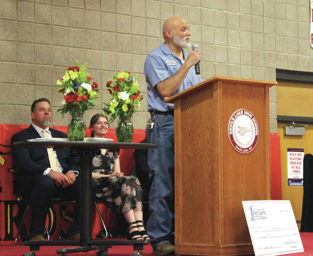 Devils Lake High School custodian Todd Dauphinais says a few words (Thanks, everybody. Thats it!) after being chosen as Support Staff of the Year on Wednesday afternoon, April 1, at the school assembly in the Devils Lake High School Sports Center gymnasium.
                                 Photo by Mark C. Robinson