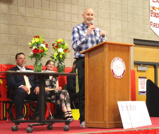 Jerad Lehmann addresses the crowd after being chosen as the Teacher of the Year on Wednesday afternoon, April 1, at the school assembly in the Devils Lake High School Sports Center gymnasium.
                                 Photo by Mark C. Robinson