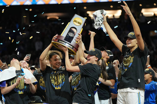 UCLA players celebrate after defeating South Carolina in the womens National Championship Final Four NCAA college basketball tournament game, Sunday, April 5, 2026, in Phoenix.
                                 AP Photo/Rick Scuteri