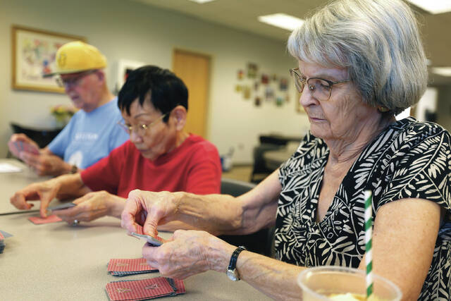 From left, Earl Nelson, Masayo Sollid and Marlys Young, all of Fargo, play a card game with fellow senior citizens on Wednesday, July 2, 2025, at the Ed Clapp Park Senior Center in south Fargo.
Anna Paige / The Forum