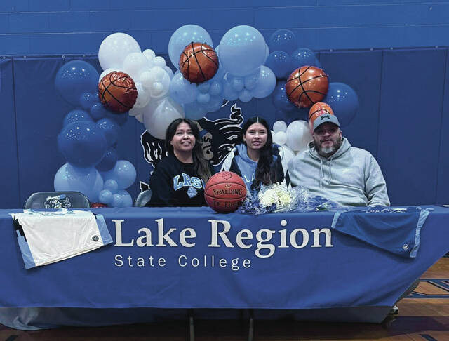 Dru Longies parents celebrate with her.
                                 Photo courtesy of Four Winds Sports