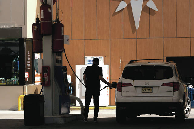 FILE - A person gets gas at a station March 10, 2026, in New York.
                                 AP Photo/Yuki Iwamura, File