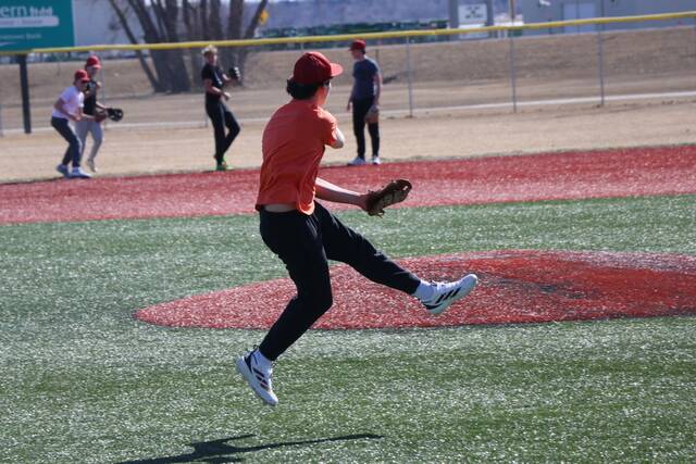 Third baseman Easton Kraft jumps as he follows through on a throw.
                                 Photo by Mojo Hill