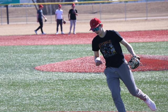 Third baseman Ben Brodina runs back to his position after making the throw on a slow roller.
                                 Photo by Mojo Hill