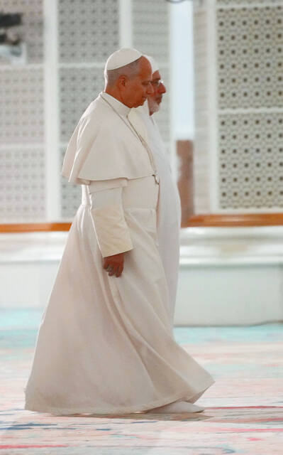 Pope Leo XIV is welcomed by Rector Mohamed Mamoun Al Qasimi upon his arrival at the Great Mosque in Algiers, Monday, April 13, 2026, on the first day of an 11-day apostolic journey to Africa. 
                                 AP Photo/Andrew Medichini
