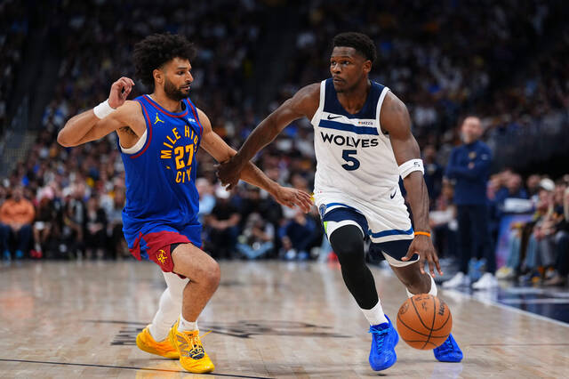 Minnesota Timberwolves guard Anthony Edwards (5) drives to the basket against Denver Nuggets guard Jamal Murray (27) during the second half in Game 2 of a first-round NBA playoffs basketball series Monday, April 20, 2026, in Denver.
                                 AP Photo/Jack Dempsey