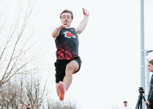 Devils Lakes Finley Wirth leaps in the air while competing in the long jump.
                                 Photo by Cameron Carlson