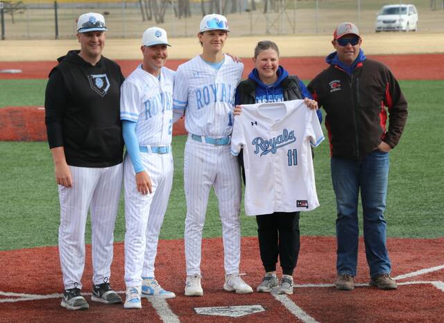 Beau Brodina poses with his parents and coaches before the Royals Sophomore Night game at DLYA Field.
                                 Photo by Mojo Hill